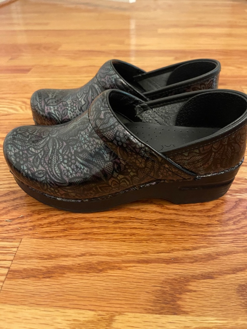 Dansko Black Iridescent Floral Clogs